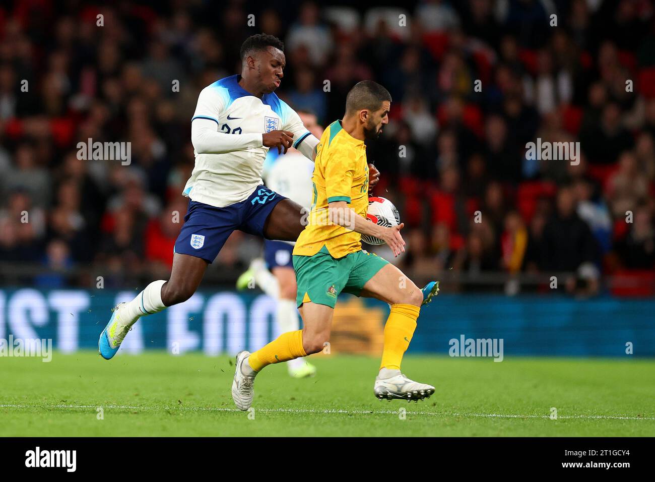 Wembley Stadium, London, UK. 13th Oct, 2023. International Football Friendly, England versus Australia; Eddie Nketiah of England challenges Aziz Behich of Australia Credit: Action Plus Sports/Alamy Live News Stock Photo
