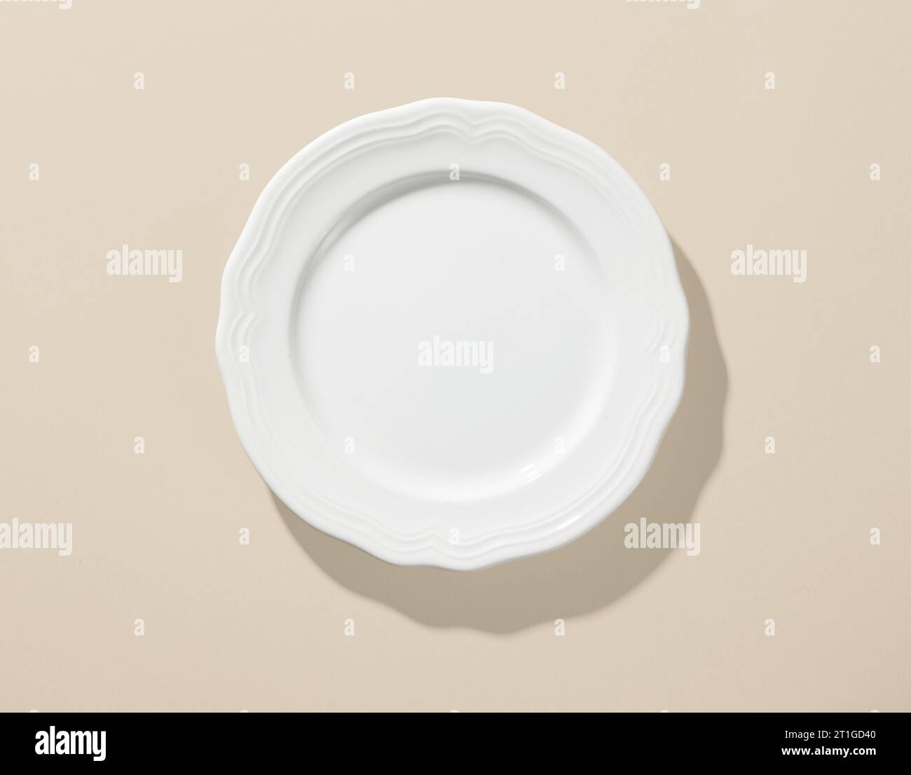 white empty plate on beige color background, top view Stock Photo