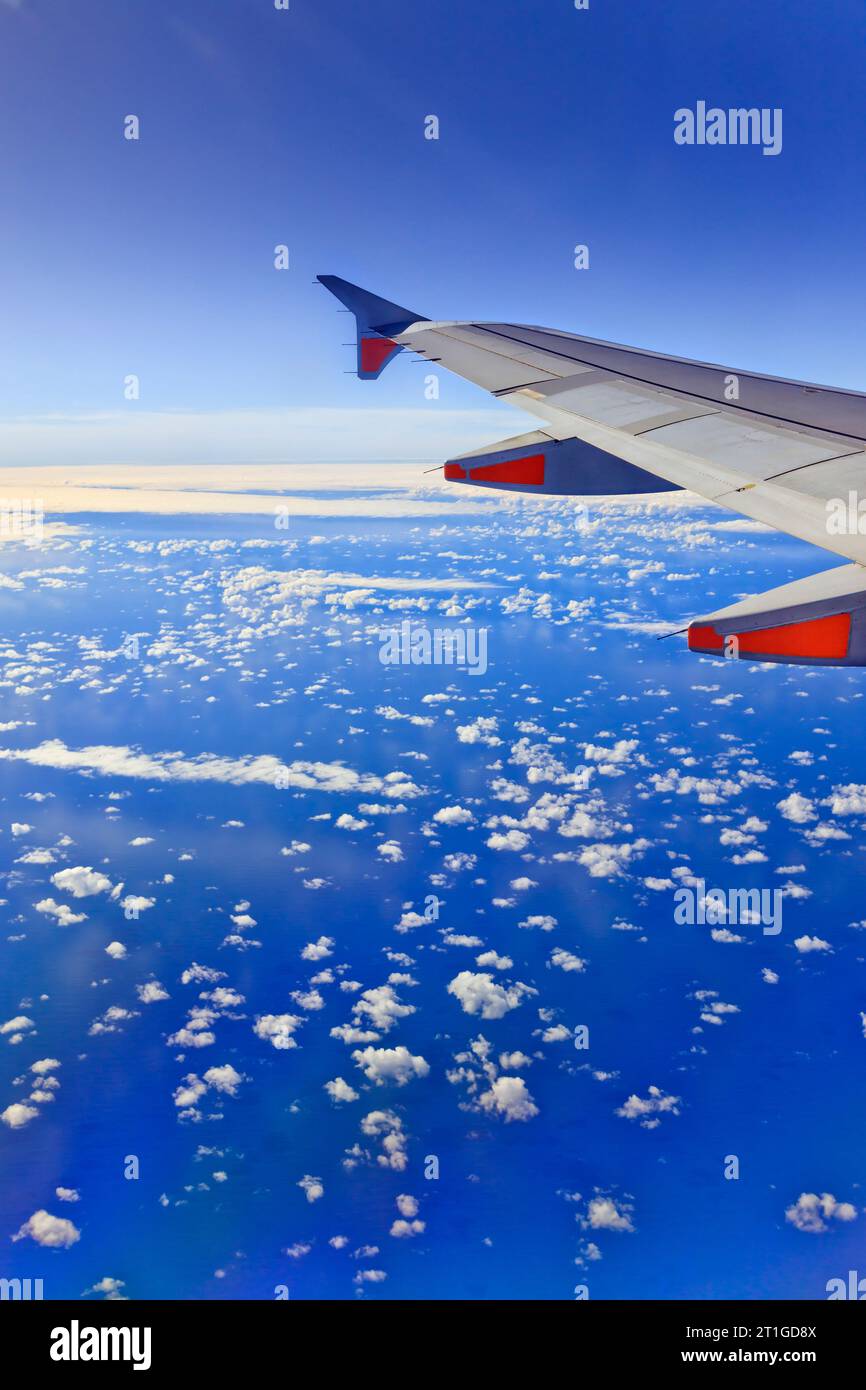 Passenger airplane en route over Pacific ocean above Tasman sea high crusing altitude thorugh deep blue sky. Stock Photo