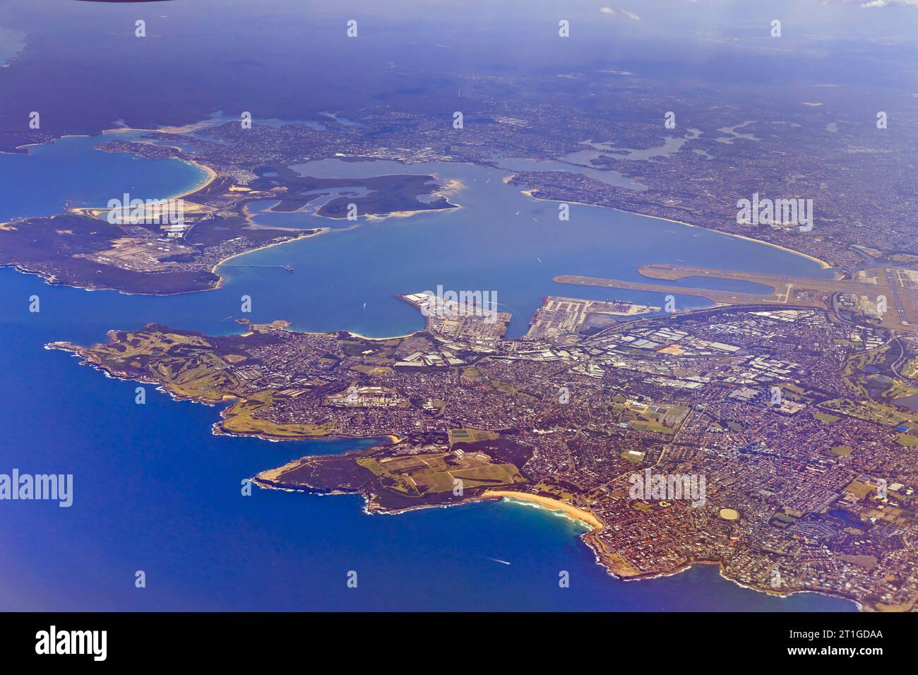 Transport hub of Port Botany and Sydney International airport in Sydney around Botany bay - aerial altitude view of the coast. Stock Photo