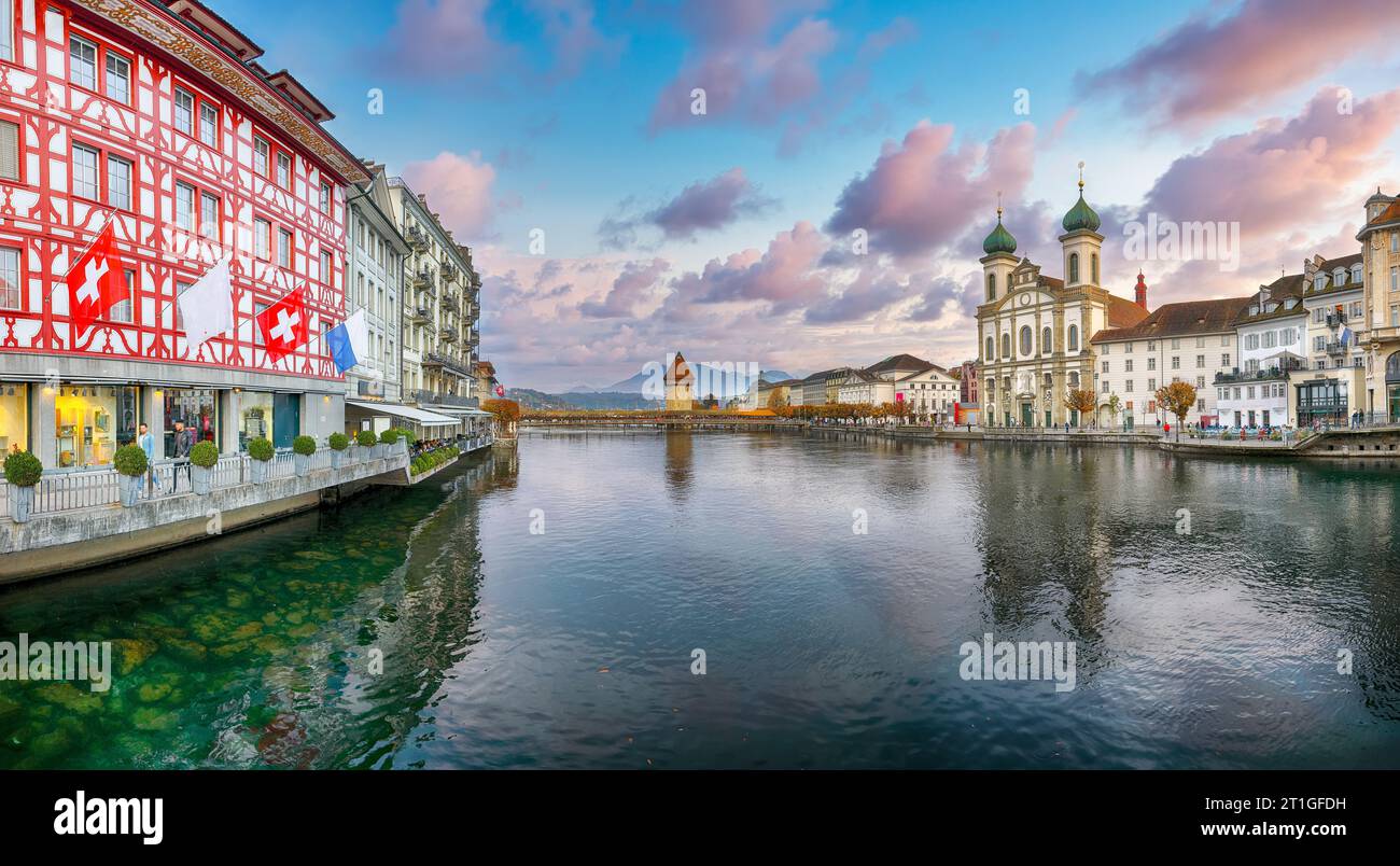 Gorgeous historic city center of Lucerne with famous buildings, old wooden Chapel Bridge (Kapellbrucke) and Jesuitenkirche Church. Popular travel dest Stock Photo