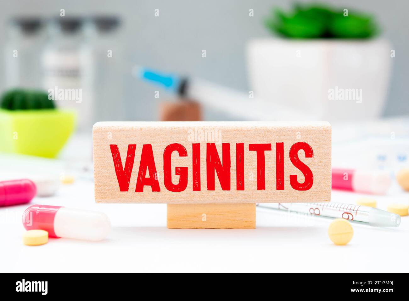 On the desktop is a stethoscope, documents, a pen, and a red file folder with the text VAGINITIS. Medical concept. Stock Photo