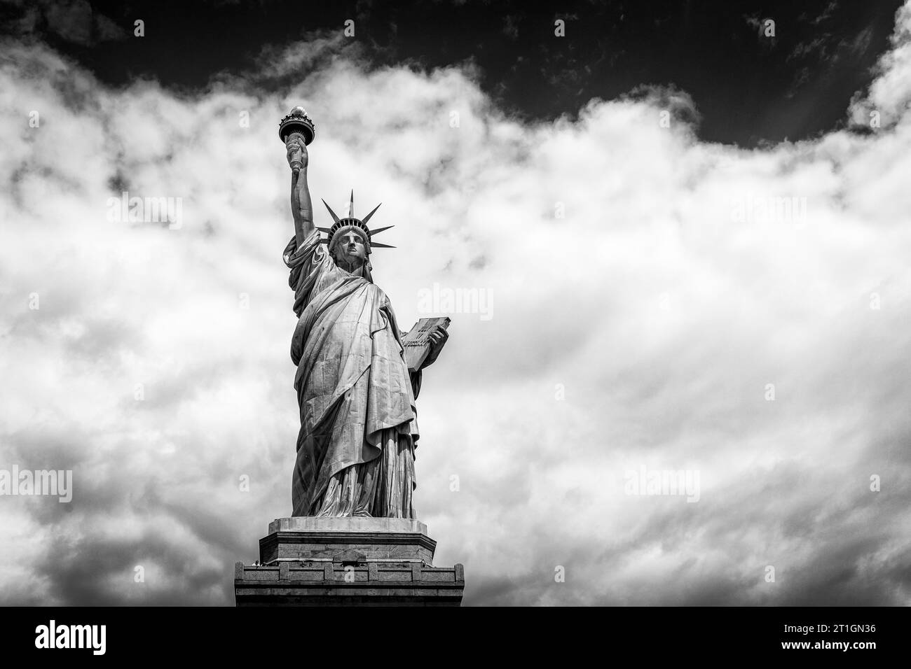 The Statue of Liberty rises into the clouds near 4New York City, USA. Stock Photo