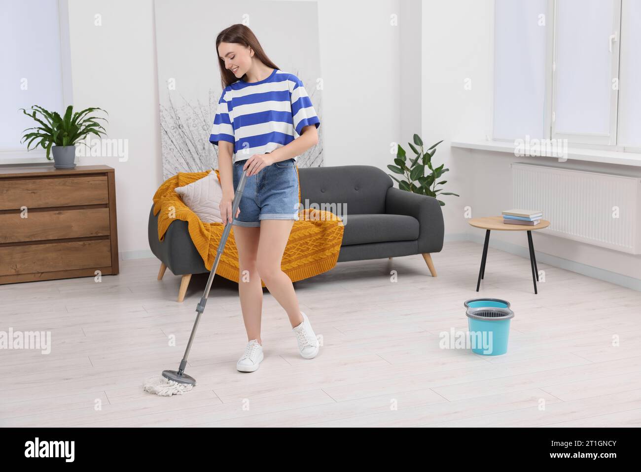 Girl washes the floor. Young beautiful happy woman cleans the floor with a  wet mop. Housekeeper does the cleaning. Vector illustration isolated on whi  Stock Vector Image & Art - Alamy