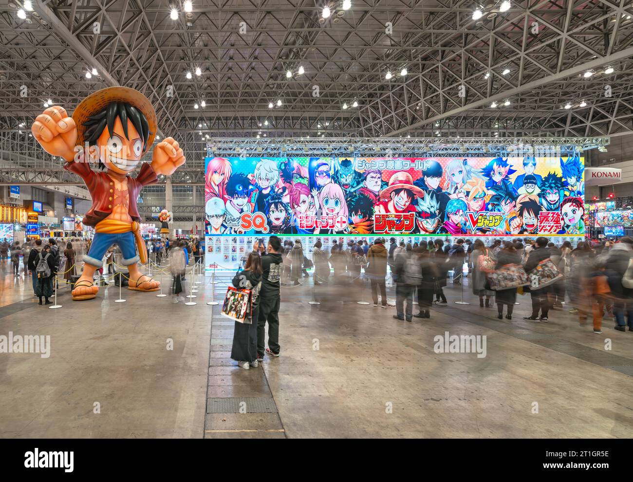 chiba, japan - dec 18 2022: Inflatable manga character of Japanese anime series One Piece raising arms in air welcoming consumers aside a huge placard Stock Photo