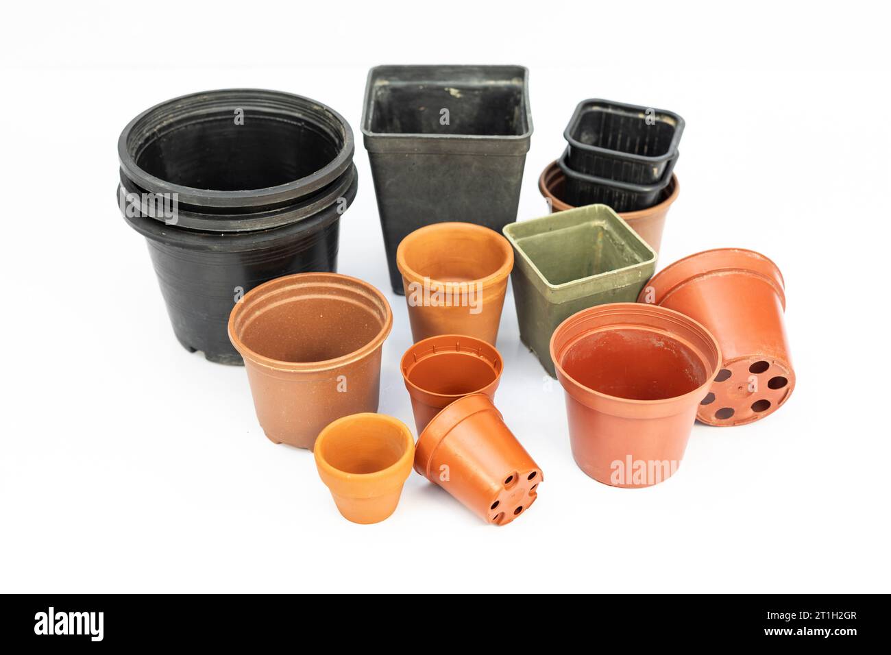 Different sizes and shapes of plastic pots for plants isolated on white background Stock Photo