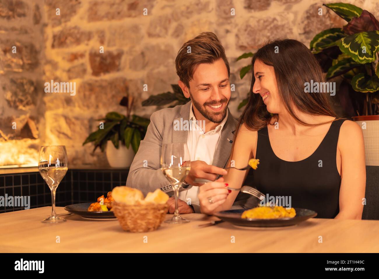 Lifestyle, a young european couple in a restaurant, having fun having dinner together with food, celebrating valentine Stock Photo