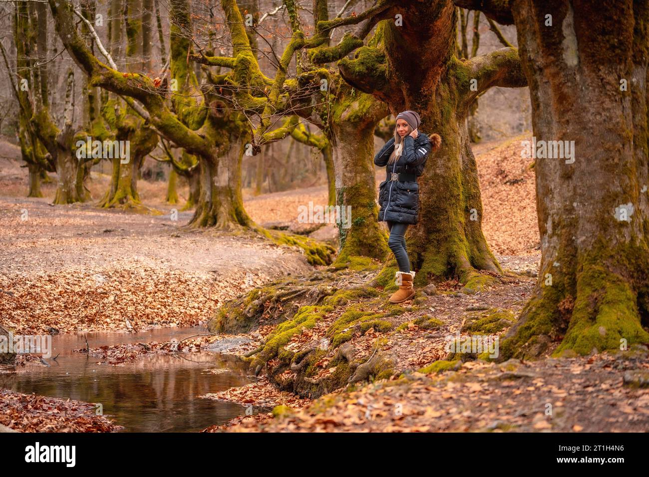 A young woman next to the Otzarreta Forest river in the Gorbea natural park, Bizkaia. Basque Country. Lifestyle session Stock Photo