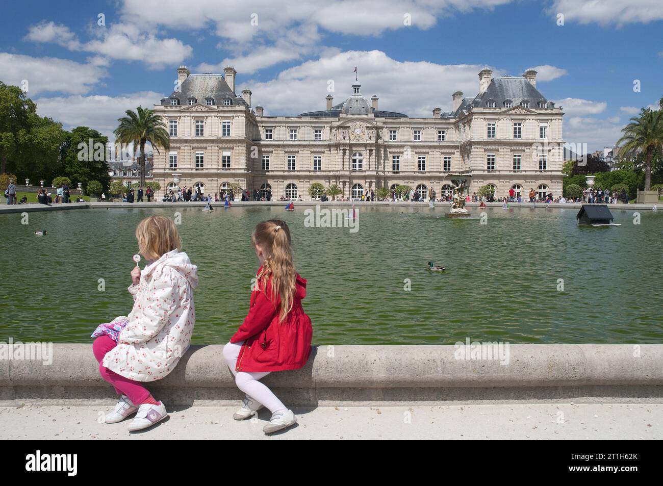 Parisian children relax in the grounds of the 17th-century Palais du Luxembourg, now housing the French Senate, in the 15th arrondissement Stock Photo