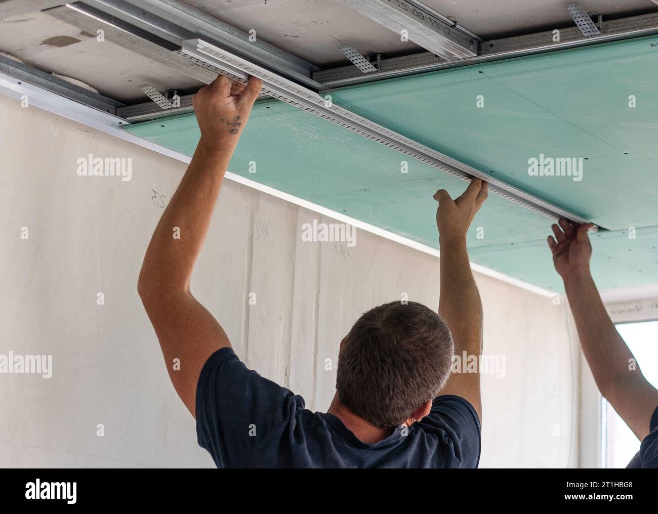 Man fasten ceiling profiles in hi-res stock photography and images - Alamy