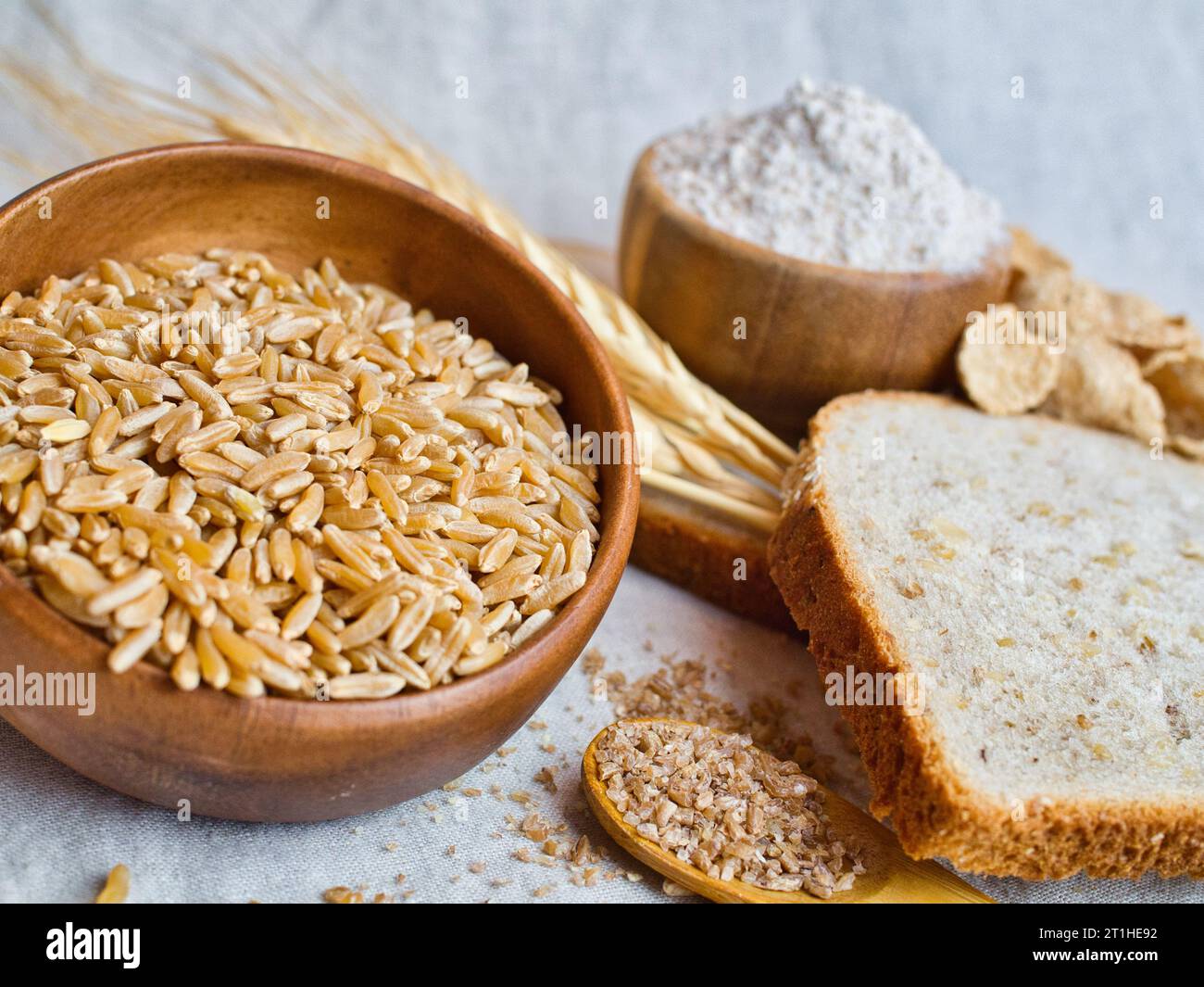 Beautiful still life arrangement of variety of wheat products; kamut, bulgur, flour, grain bread, and wheat cereal. Image contains gluten. Stock Photo