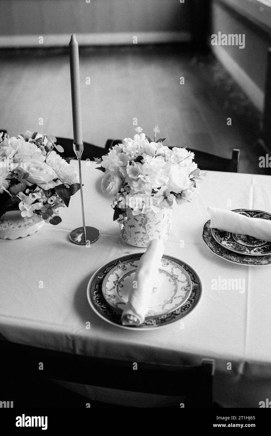 A black and white of a beautifully set dinner wedding table in front of