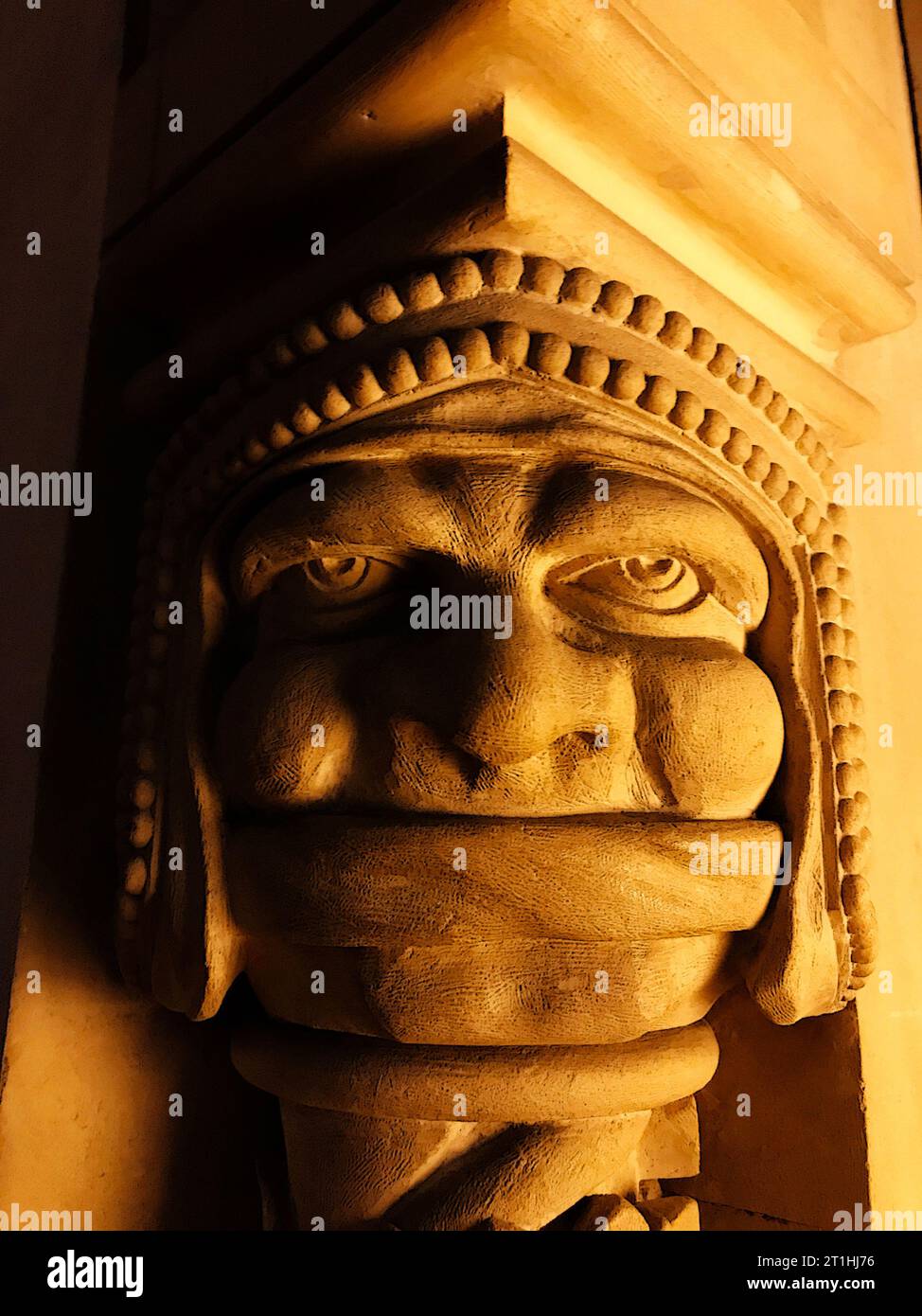 Artwork of mascaron ornament as a column capital, these frightening or chimeric faces were originally put on buildings to frighten away evil spirits. Stock Photo