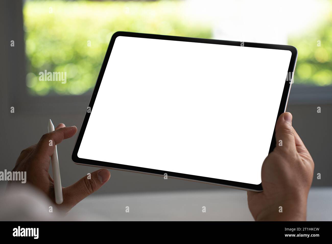 Digital tablet computer close up man using tablet hands man multitasking with isolated screen Stock Photo