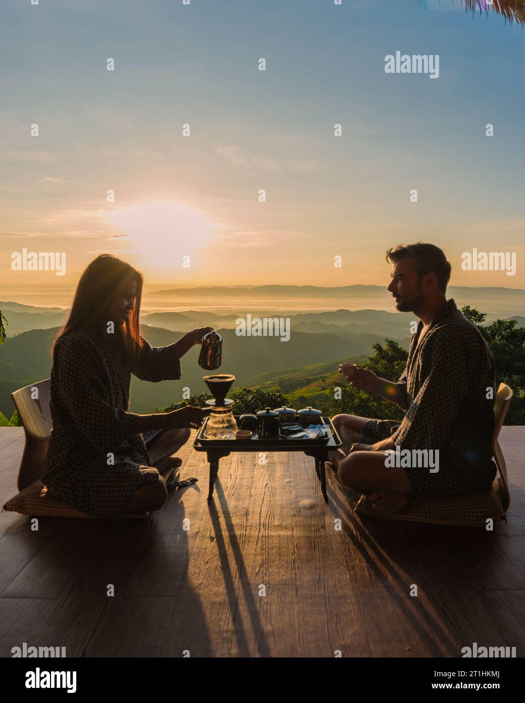 a couple on vacation in Thailand waking up with drip coffee in the morning during vacation, with a look at the mountains of Doi Chang Chiang Rai Thailand Stock Photo