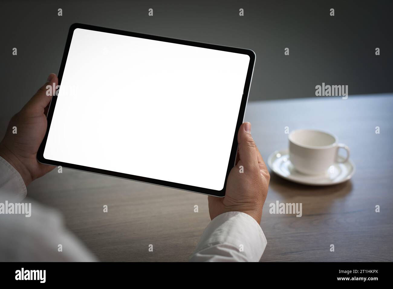 Digital tablet computer close up man using tablet hands man multitasking with isolated screen Stock Photo
