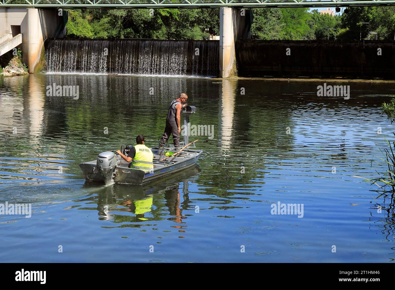 Removing algae with a machine in the Lez River. Philip Brothers Company. Montpellier, Occitanie, France Stock Photo