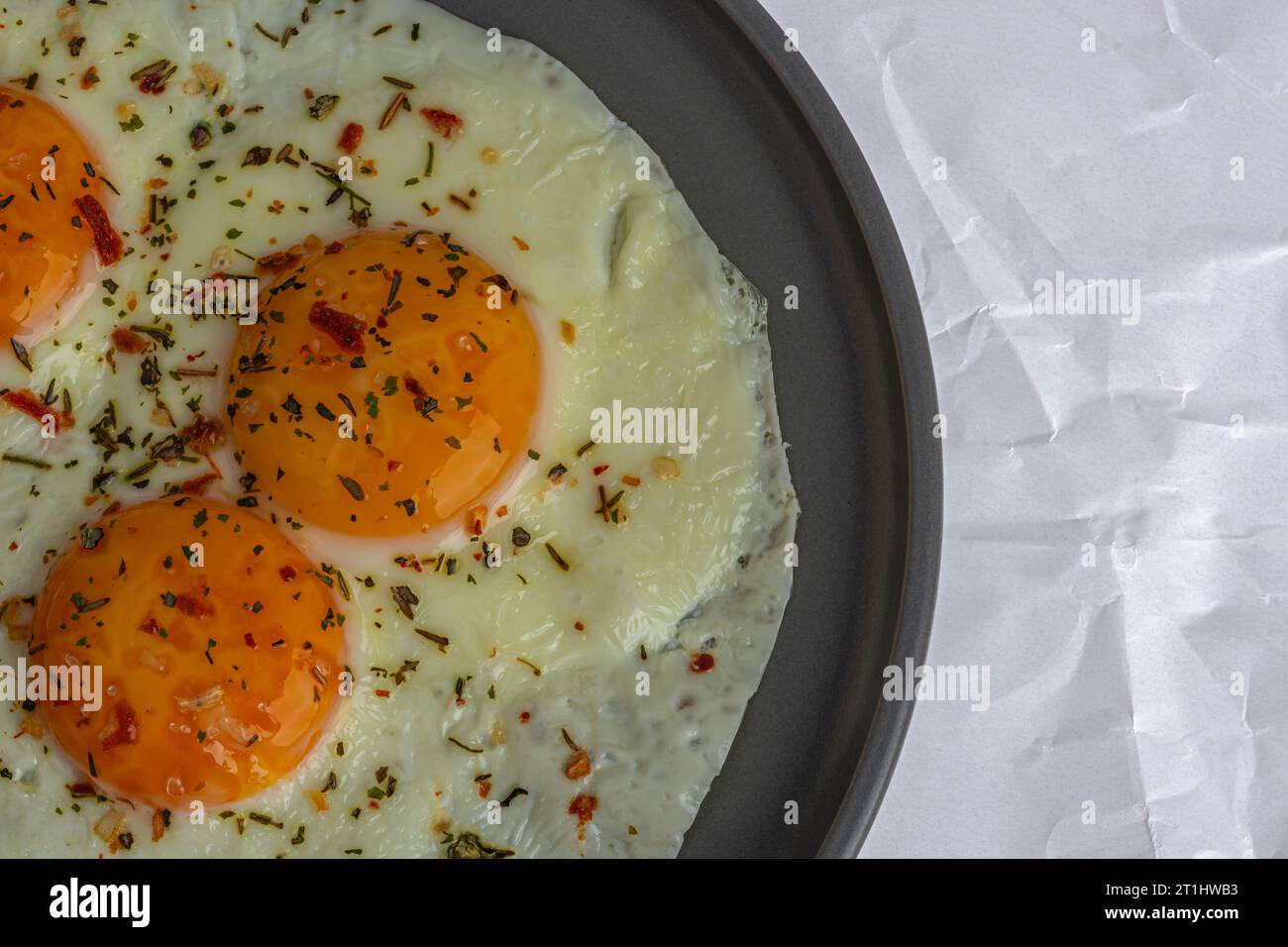 scrambled eggs with spices on a gray plate top view close up Stock Photo