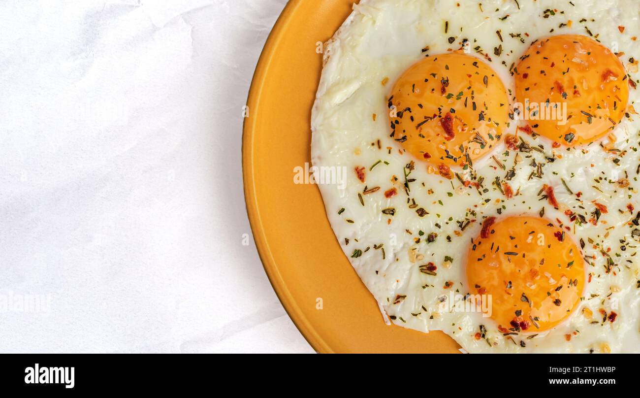 scrambled eggs with spices on an orange plate, top view Stock Photo - Alamy