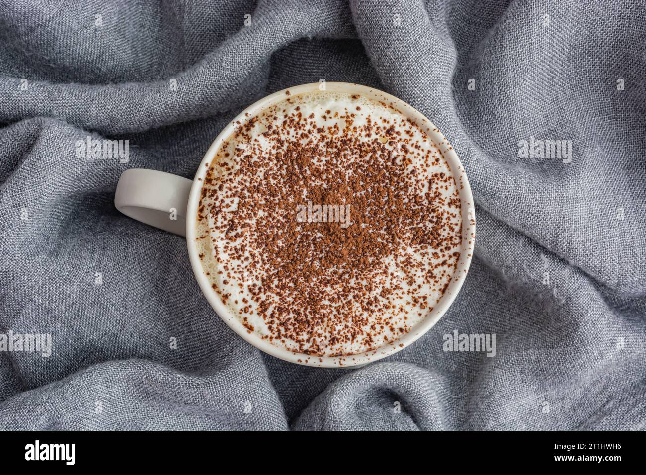 cup of coffee on gray fabric background top view Stock Photo