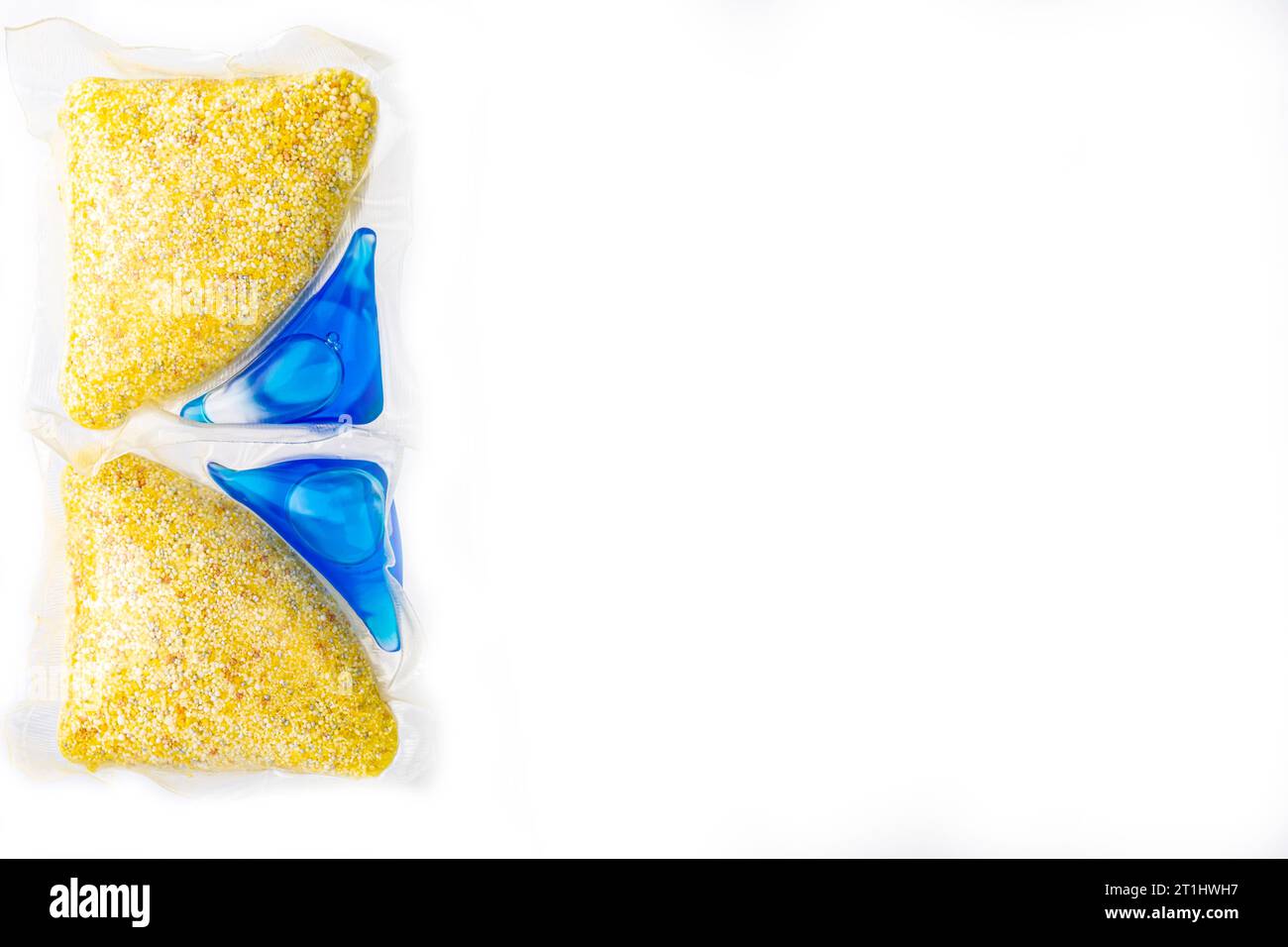 capsules with yellow powder and blue dishwasher gel place for inscription Stock Photo