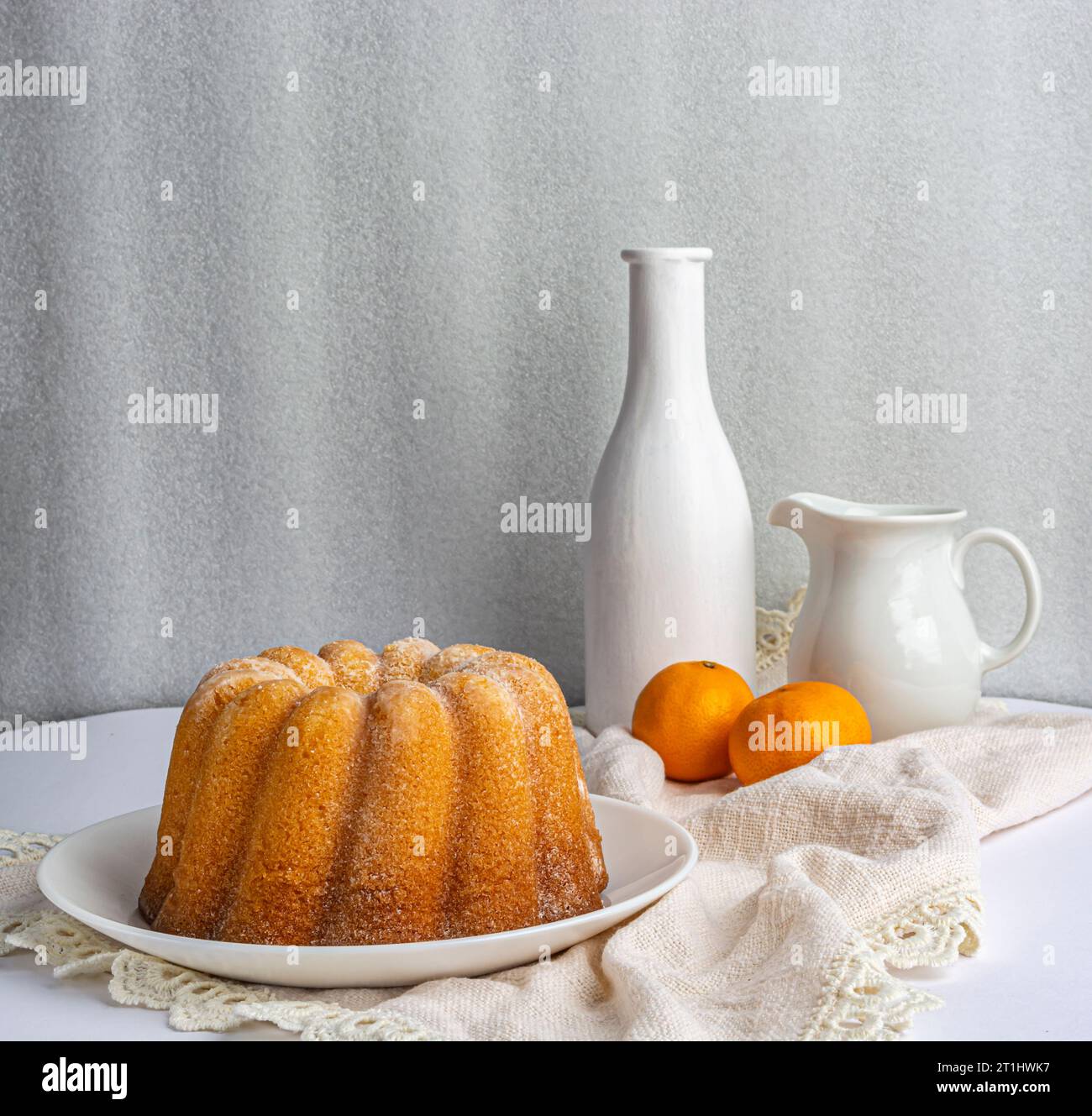 cupcake on a white napkin, two tangerines Stock Photo