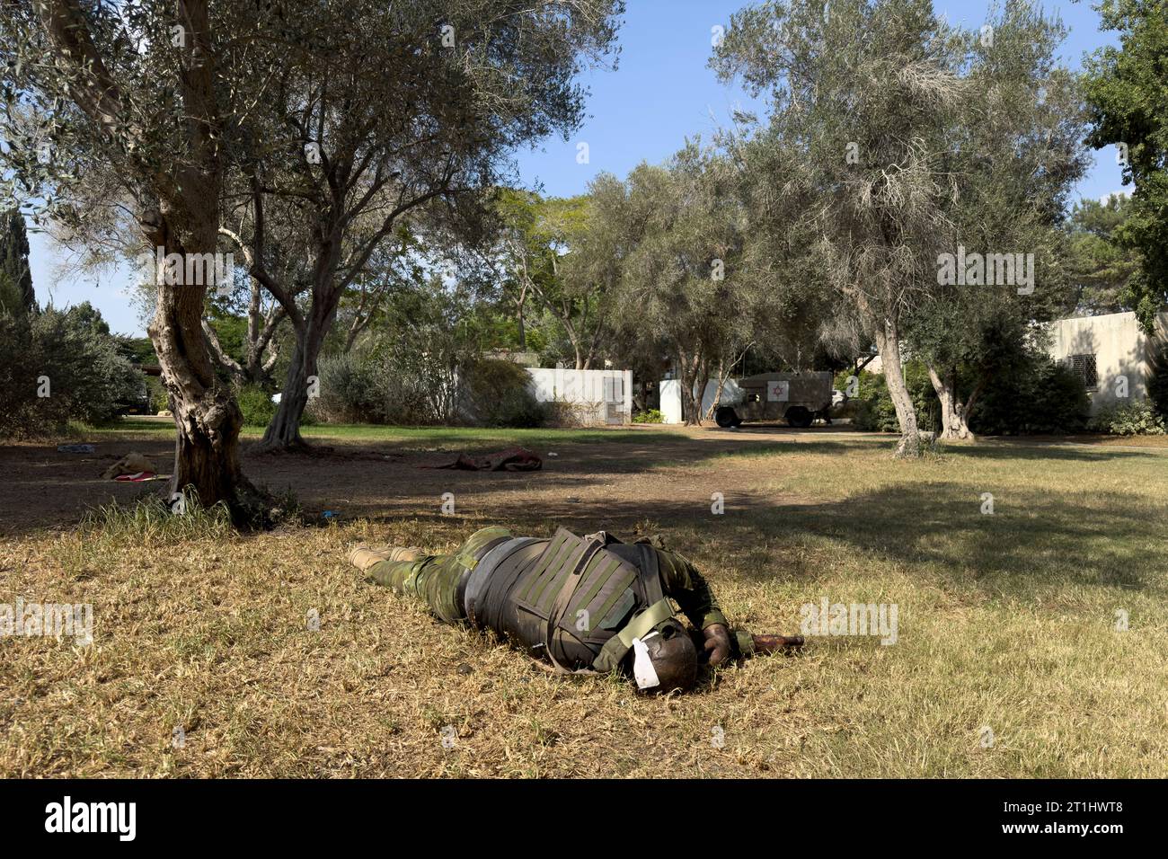 The body of a Palestinian fighter lays in Kibbutz Kfar Aza where Hamas militants killed families in their homes after they have infiltrated into Israel from the Gaza Strip on October 10, 2023 in Kfar Aza, Israel. On Saturday, the Palestinian militant group Hamas launched the largest surprise attack from Gaza in a generation, sending thousands of missiles and an unknown number of fighters by land, who shot and kidnapped Israelis in communities near the Gaza border. Stock Photo