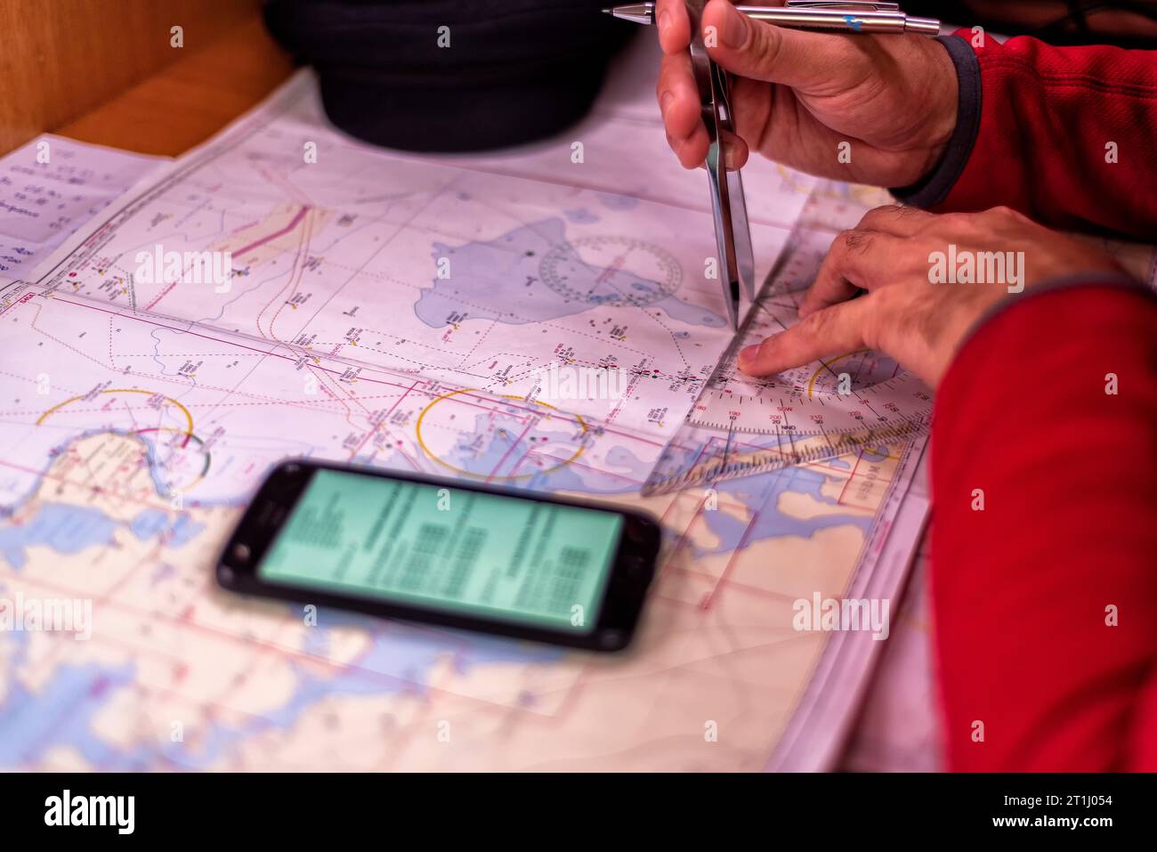 navigation with sea charts in the chart room on a sailing yacht Stock