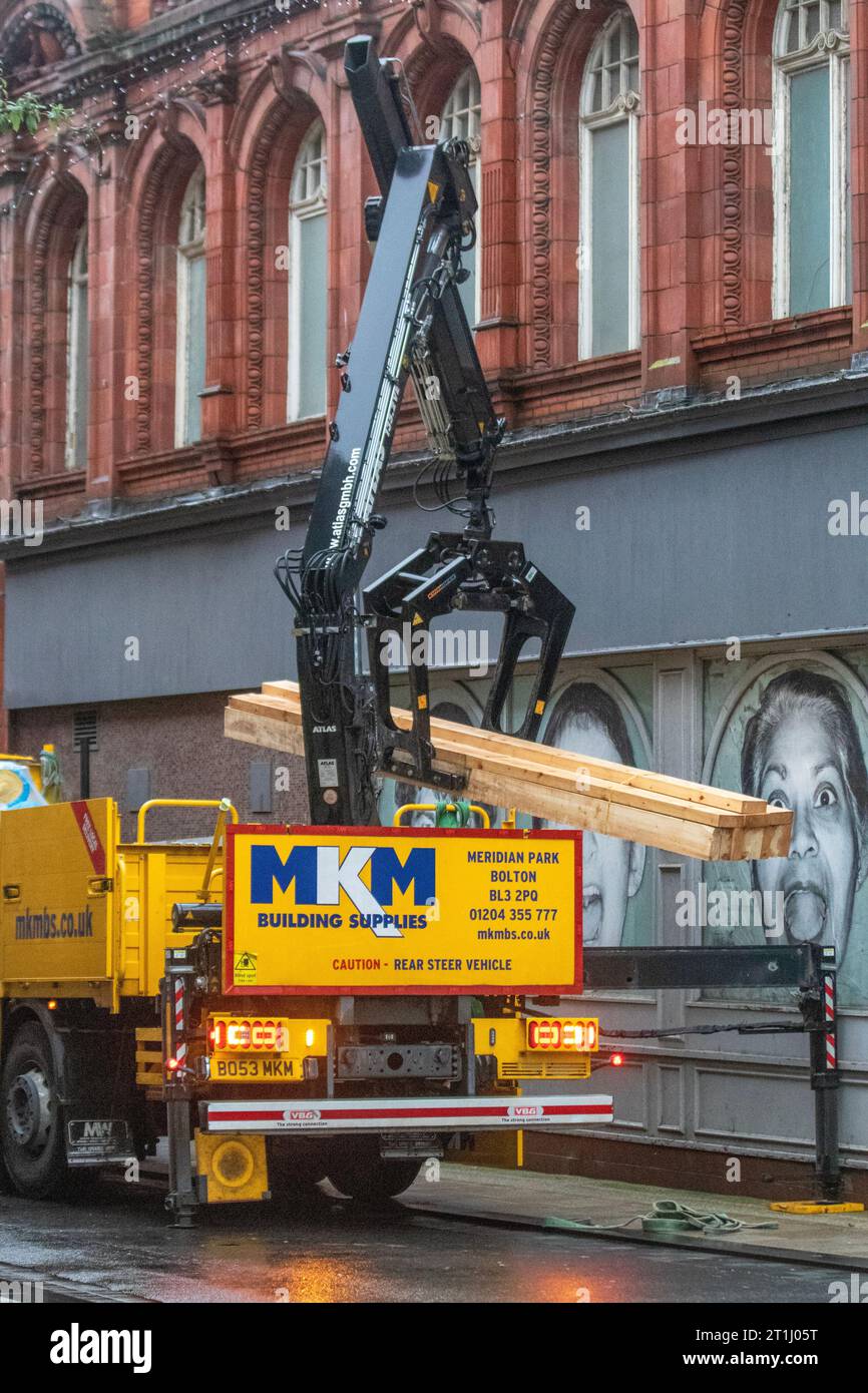 MKM Building Supplies vehicle being unloaded in Preston, UK. City regeneration of unused, abandone retail premises in the central businbess district. Stock Photo