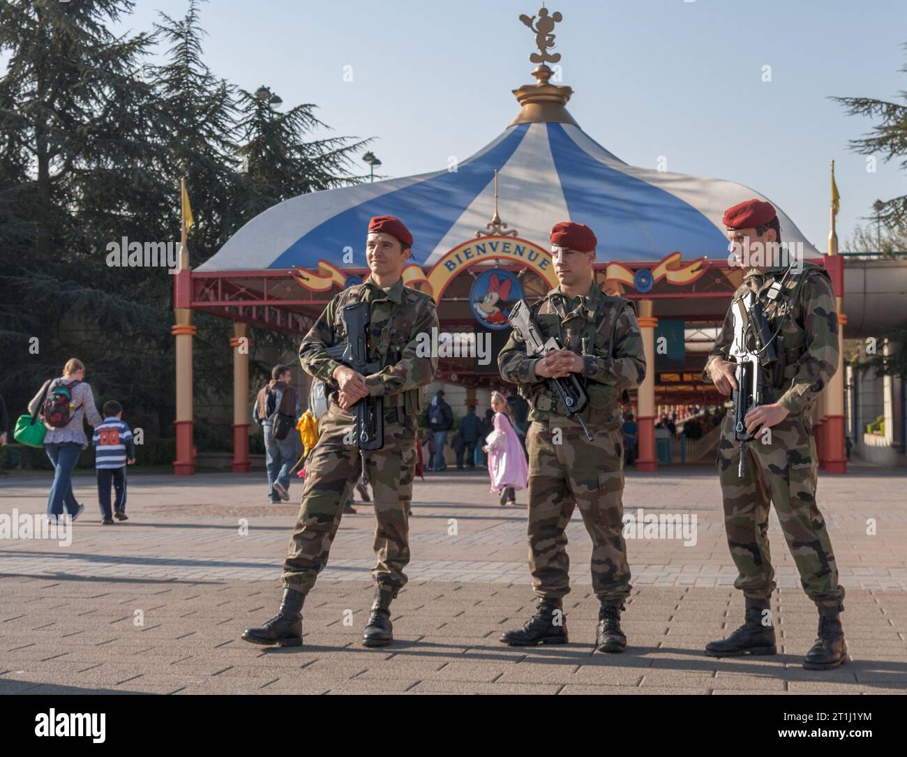 Three soldiers provide armed security in front of Disneyland Paris, France Stock Photo