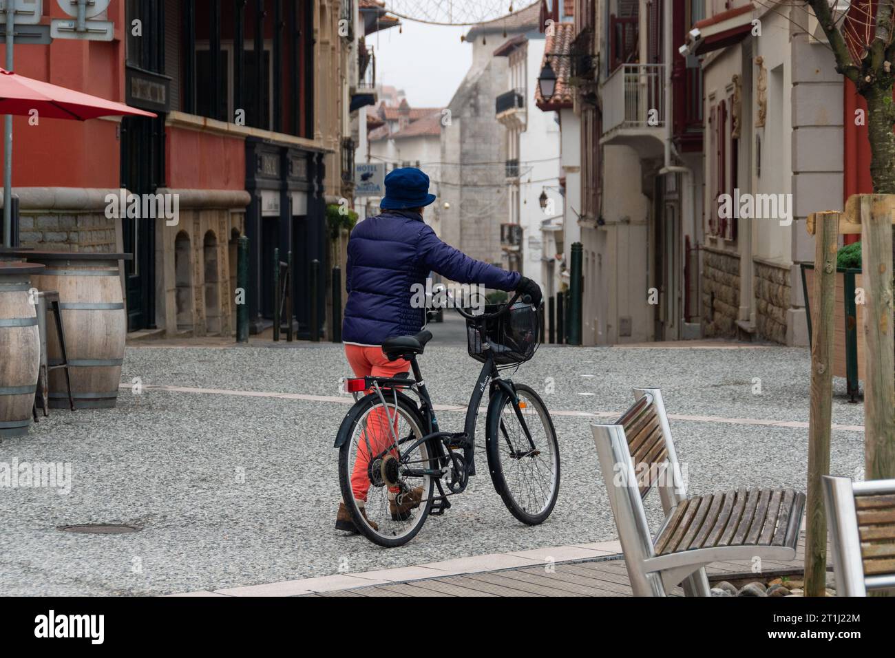 women walking with her bycicle in saint jean de luz, france Stock Photo