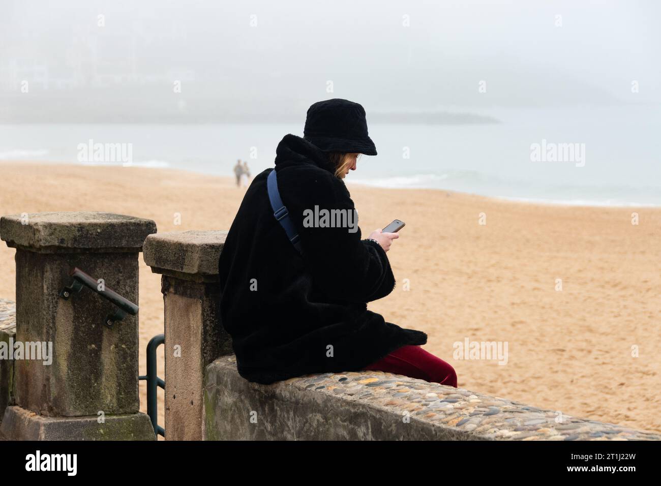 young women in the beach of saint jean de luz in winter, france Stock Photo