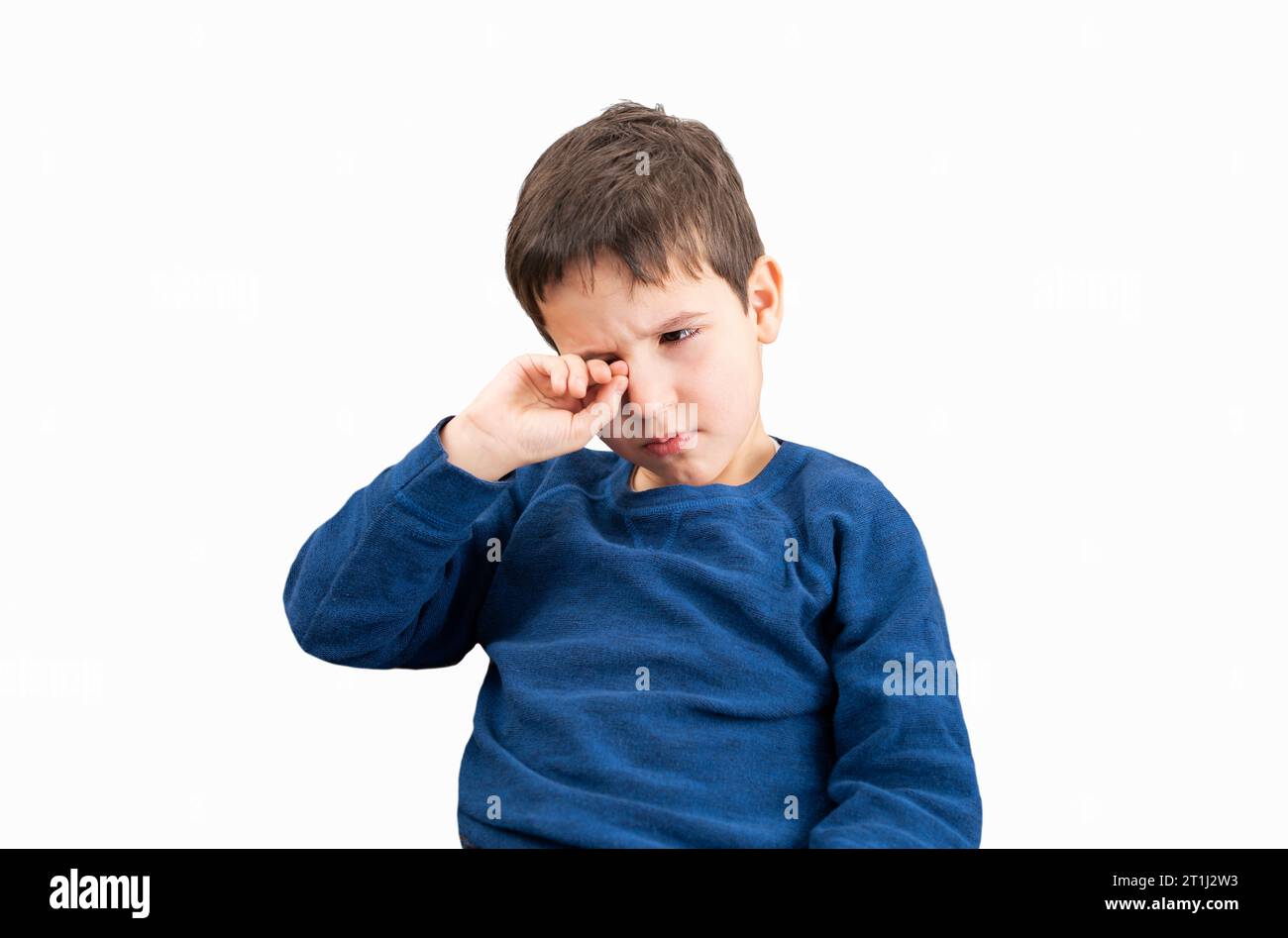 Close up of child scratching itchy eye with white background Stock