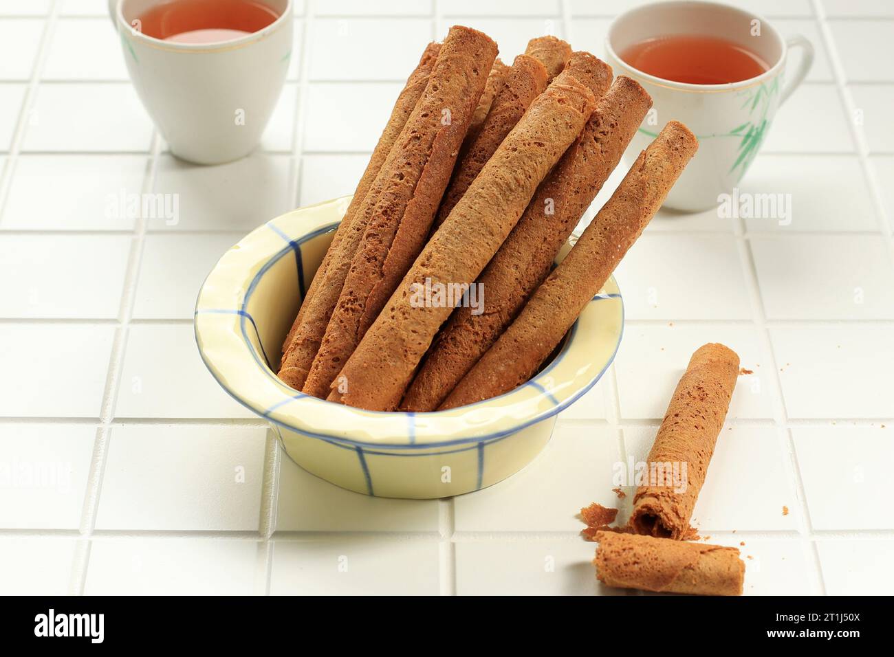 Kue Semprong or Waffle Egg Rolls, Indoneisan Traditional Cake Snack made from Flour and Sugar and Shaped like a Pipe Stock Photo