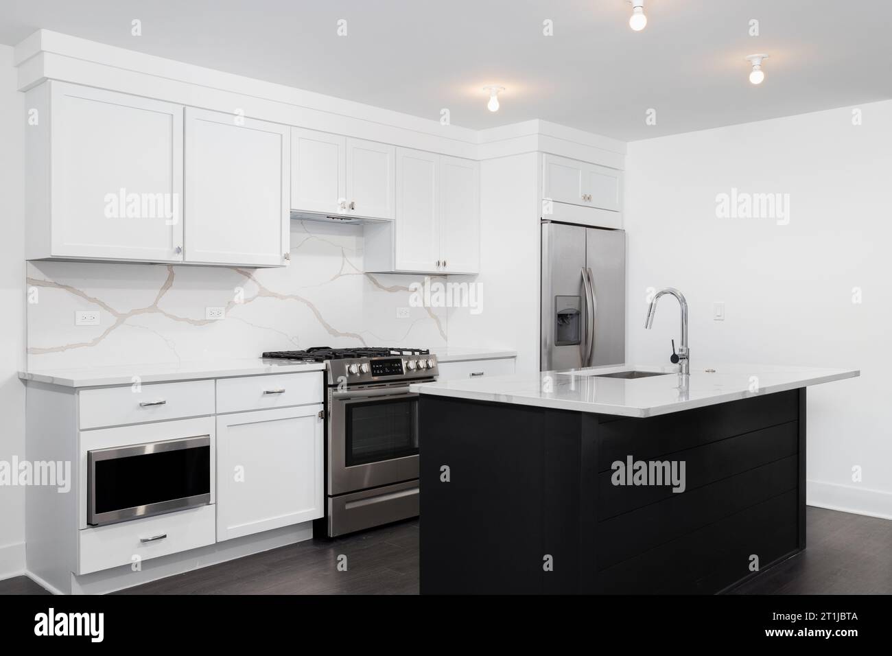 https://c8.alamy.com/comp/2T1JBTA/a-kitchen-with-white-cabinets-black-island-and-a-marble-countertop-no-brands-or-labels-2T1JBTA.jpg