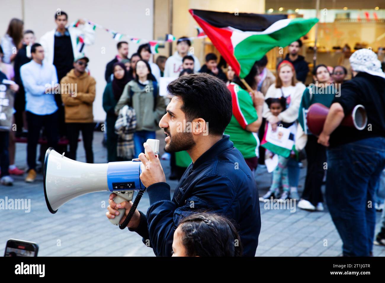 Free Palestine protest Exeter city centre - man on megaphone with girl Stock Photo