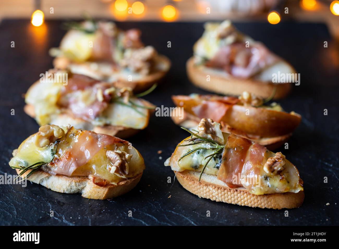 Christmas canapes made of pears, blue cheese and Parma ham Stock Photo