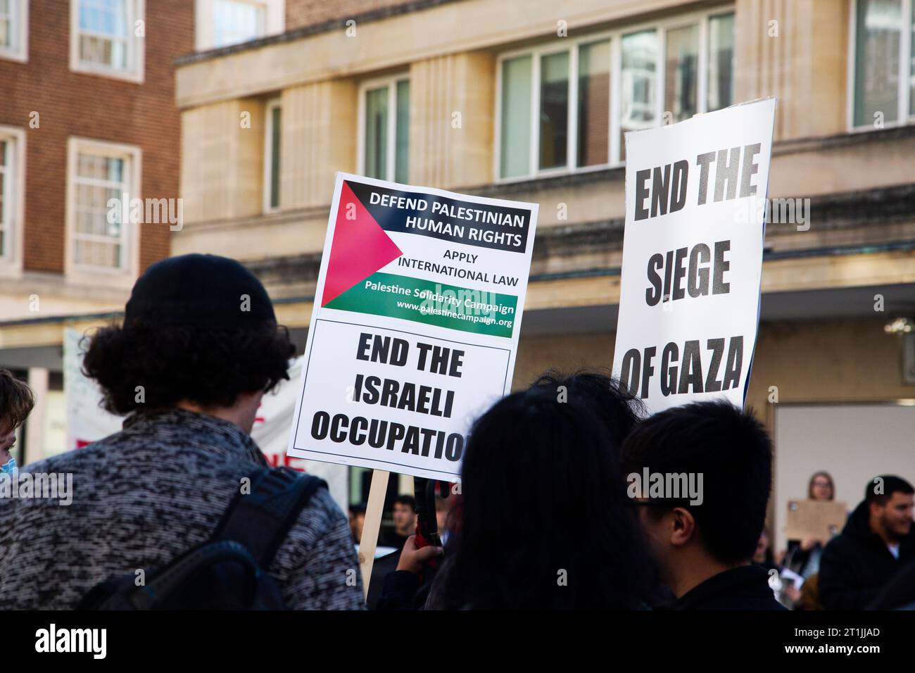 Free Palestine protest close up of signage in crowd reading End the Israel occupation / end the siege of Gaza Stock Photo