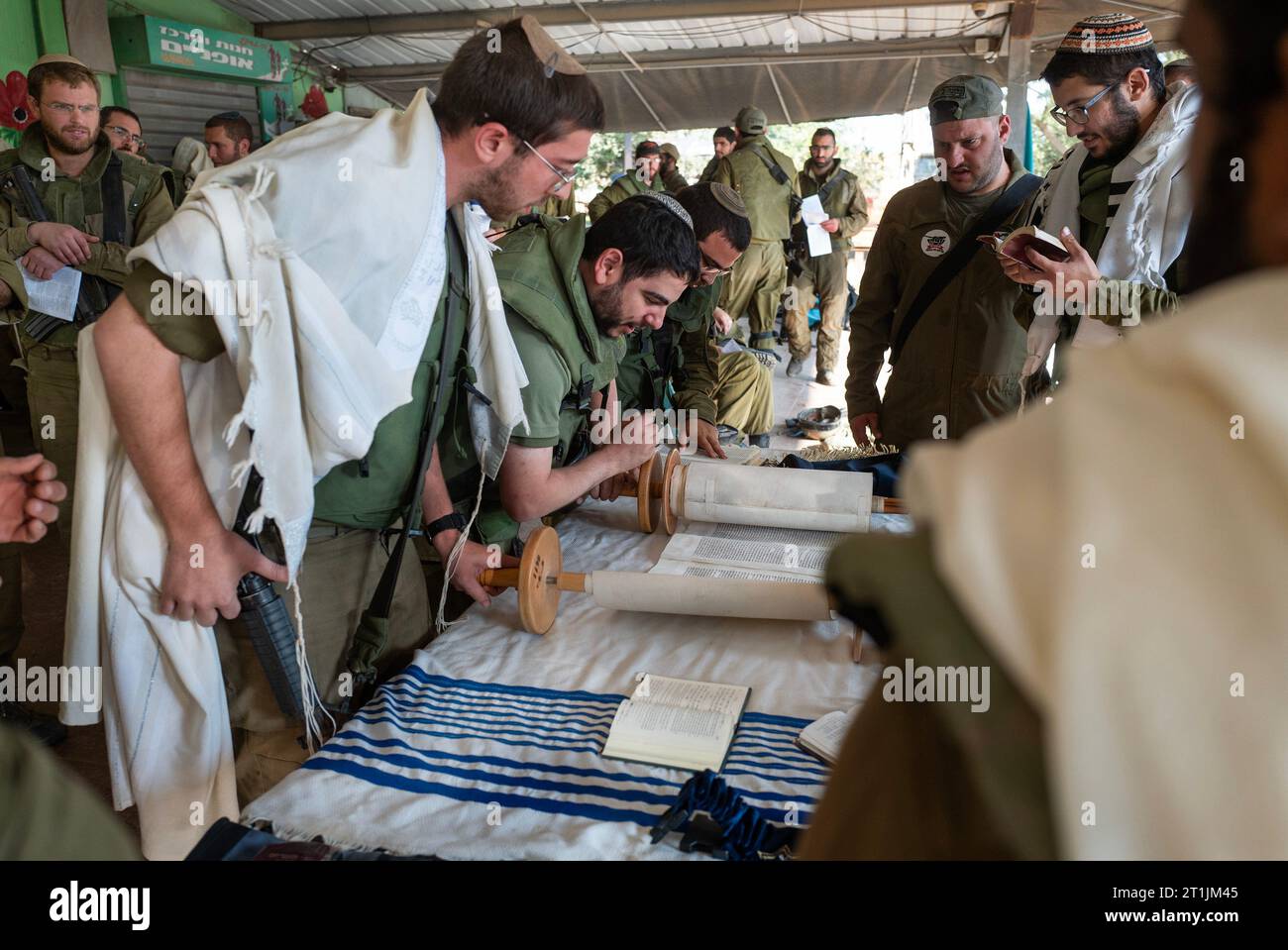 Israeli defense Forces (IDF) soldiers perform morning prayers on a staging area at the community of Be'eri very close to the Gaza Strip border on October 14, 2023. Be'eri was the scene of intense slaughter of Israeli civilians on the attack on Israel by the Hamas Palestinian group on October, 7, 2023, one week ago, when some 1500 Israelis were murdered, including some 300 IDF soldiers. Photo by Jim Hollander/UPI Credit: UPI/Alamy Live News Stock Photo