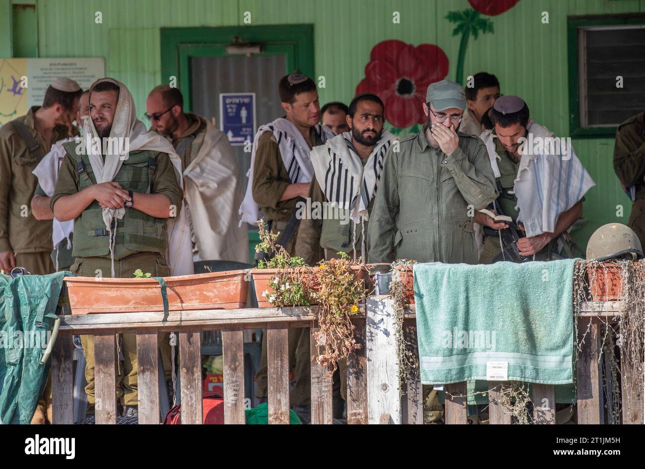 Israeli defense Forces (IDF) soldiers perform morning prayers on a staging area at the community of Be'eri very close to the Gaza Strip border on October 14, 2023. Be'eri was the scene of intense slaughter of Israeli civilians on the attack on Israel by the Hamas Palestinian group on October, 7, 2023, one week ago, when some 1500 Israelis were murdered, including some 300 IDF soldiers. Photo by Jim Hollander/UPI Credit: UPI/Alamy Live News Stock Photo