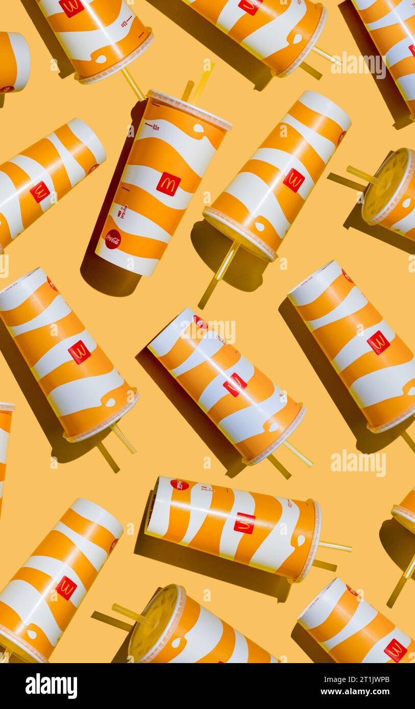 Yellow glass of McDonald's. Paper cup with lid. Takeaway drink ...