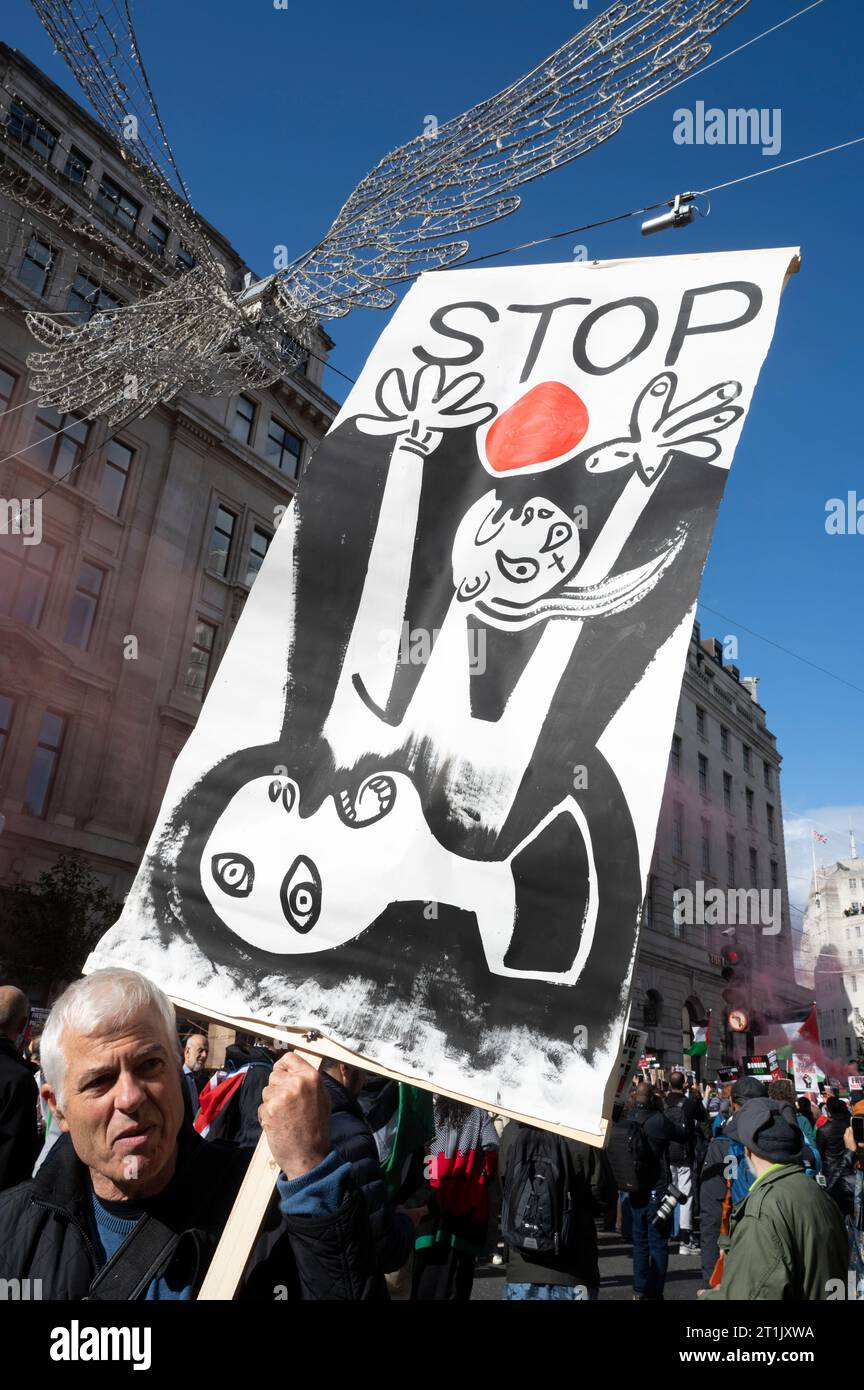 On October 14th 2023  thousands of people marched through Central London to demand an end to the bombing in Gaza.Placard based on Guernica by Picasso Stock Photo