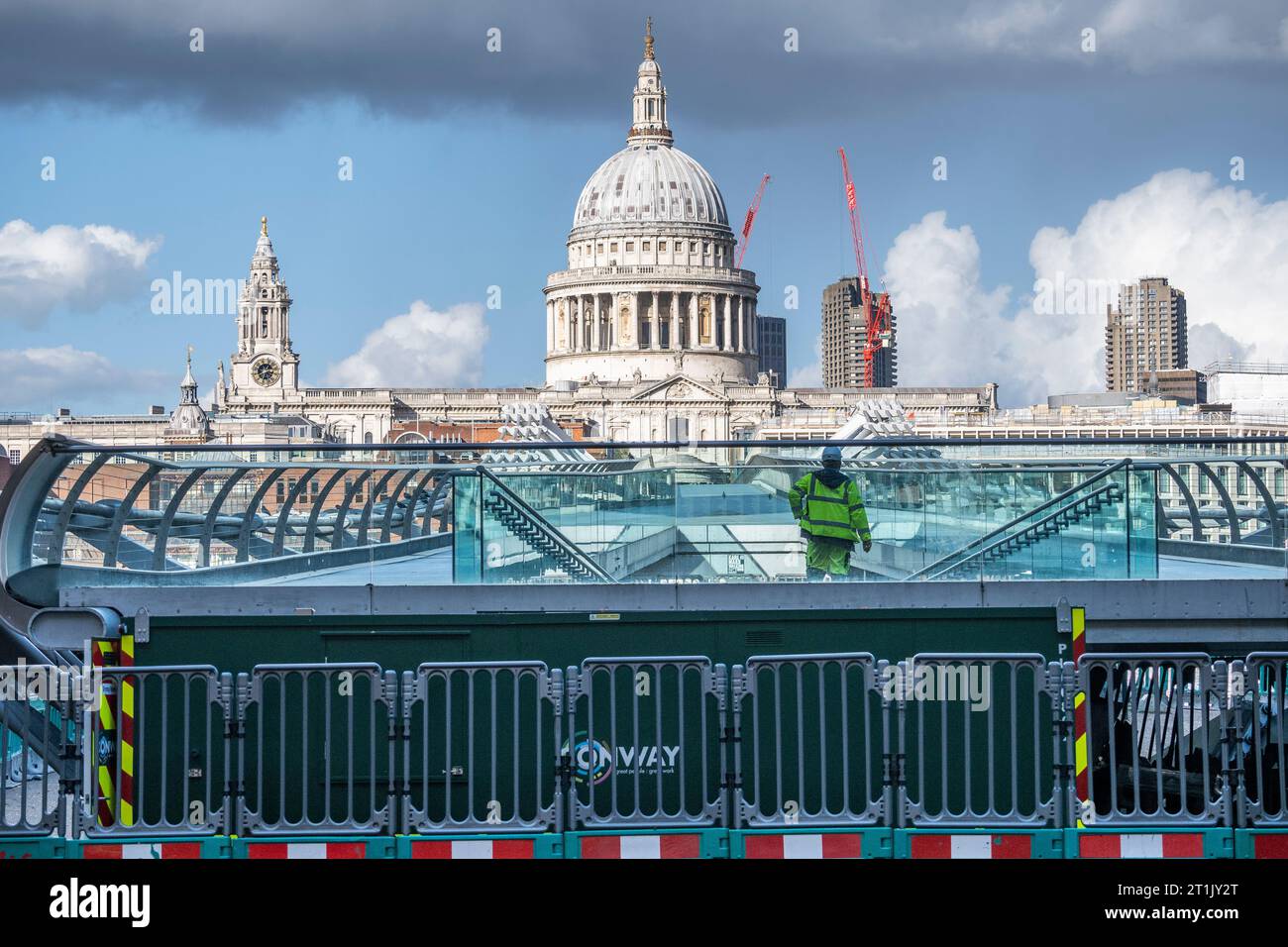 London, UK.  14 October 2023.  A workman crosses the Millennium Bridge which has closed for maintenance.  City Bridge Foundation, a charity that looks after London's major Thames crossings, says that a layer of membrane has started to degrade and needs replacing.  Repairs will take three weeks  Credit: Stephen Chung / Alamy Live News Stock Photo