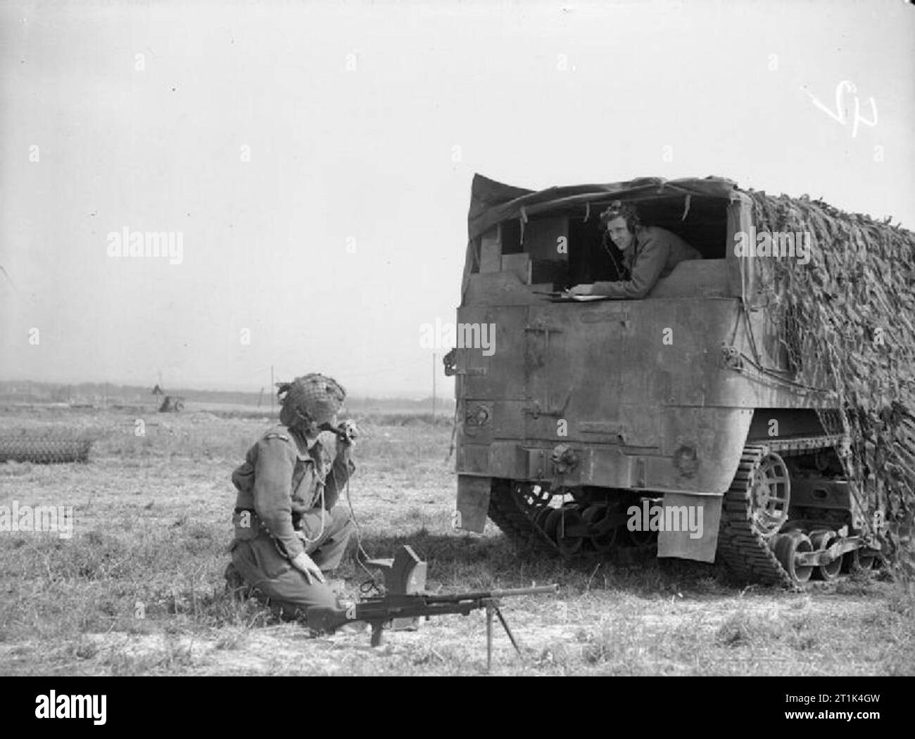The Royal Navy during the Second World War- the Campaign in Normandy, June 1944 An FOB unit (Forward Observation Bombardment) armoured lorry in operation in the Sword area. The telegraphist inside is protected from snipers by a colleague with a Bren Gun whilst the ranges are sent through to HM Ships. Sometimes a land-line is run from the lorry for a mile forward where the observation post is in action. It is men of the 'Forward Observation Bombardment' among whom are naval telegraphists, volunteers from HM ships, that the gun crews of the Royal Navy rely on for correct ranges as they bombard e Stock Photo