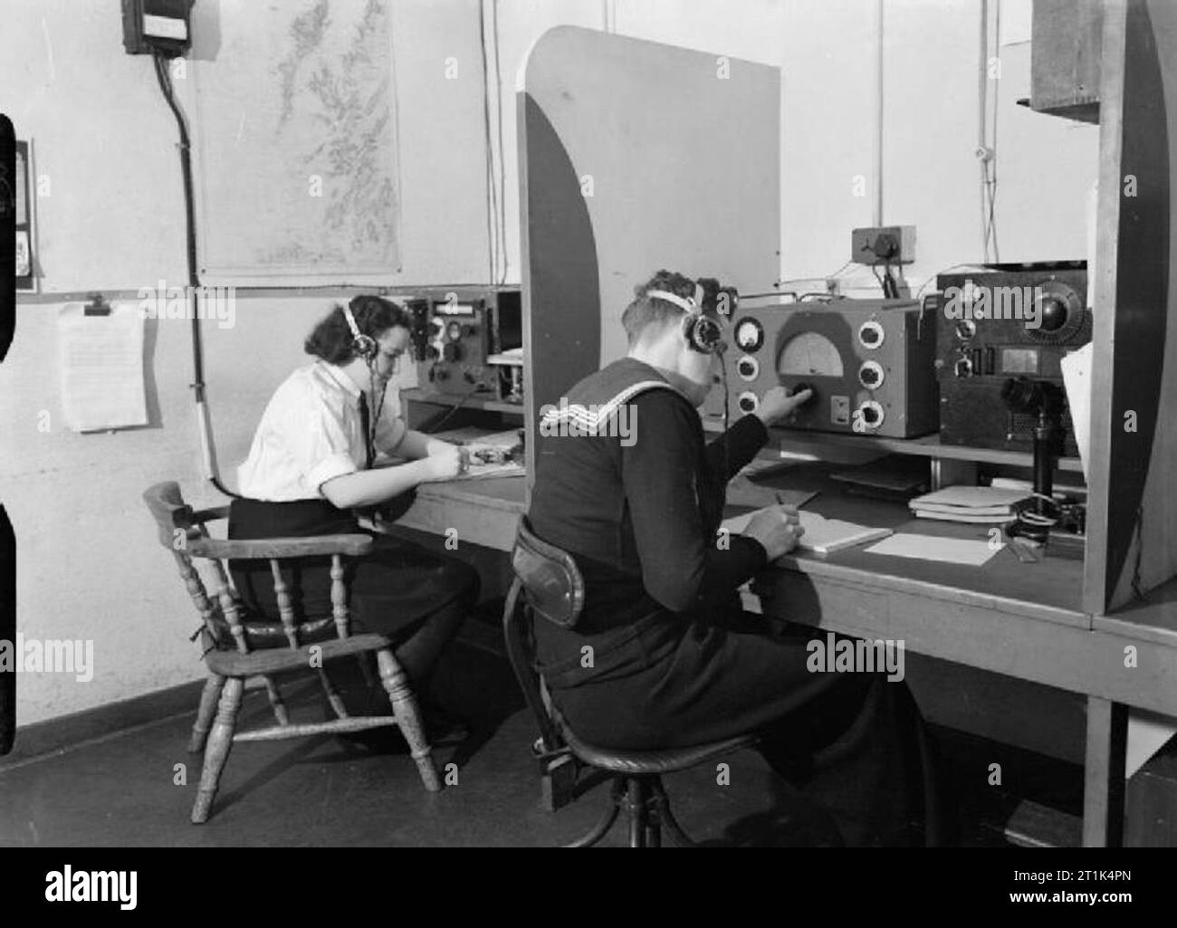 The Women's Royal Naval Service during the Second World War A Wren wireless telegraphist receiving a message from a ship on the other side of the Atlantic at the Royal Navy signal station at Greenock, Scotland. Stock Photo