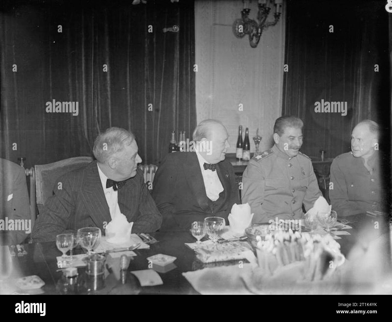 Winston Churchill during the Second World War in Iran The 'Big Three', Franklin D Roosevelt, Winston Churchill and Joseph Stalin, sit together at a dinner party held in the Victorian Drawing Room of the British Legation, Tehran, in Iran, to mark Winston Churchill's 69th birthday on 30th November 1943. Stock Photo