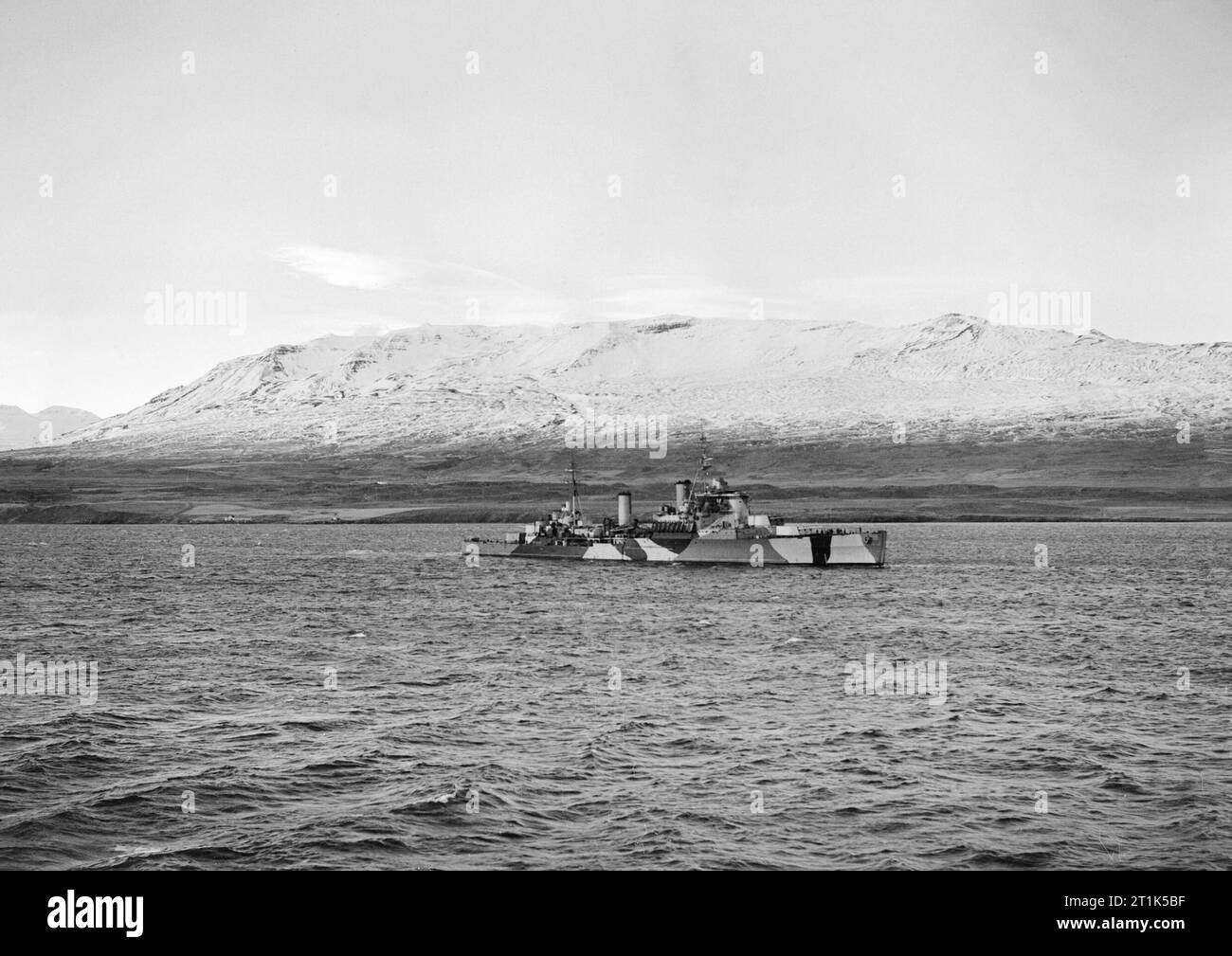 HMS JAMAICA at Hvalfjord in Iceland, October 1943. HMS JAMAICA in dazzle paint at Hvalfjord, Iceland, photographed from the aircraft carrier HMS FORMIDABLE. Stock Photo