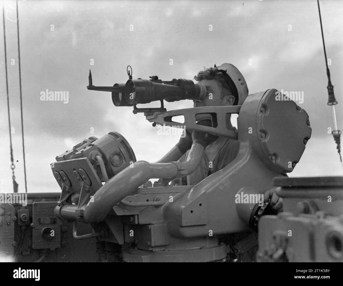 HMS Mauritius. July 1942. A lookout scanning the horizon for ships or