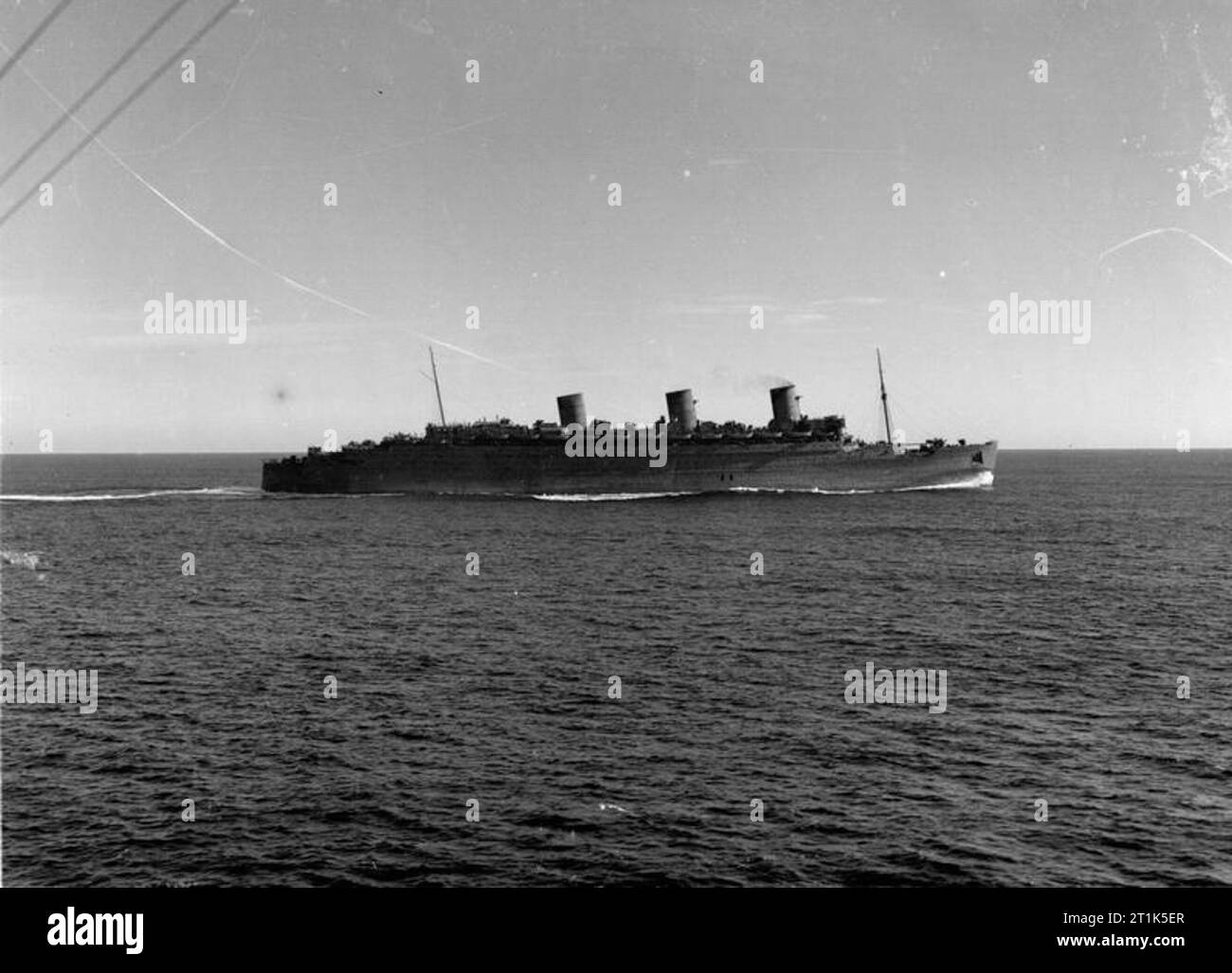 HMS Mauritius, a Fiji Class Cruiser at Sea. August 1942. The QUEEN MARY