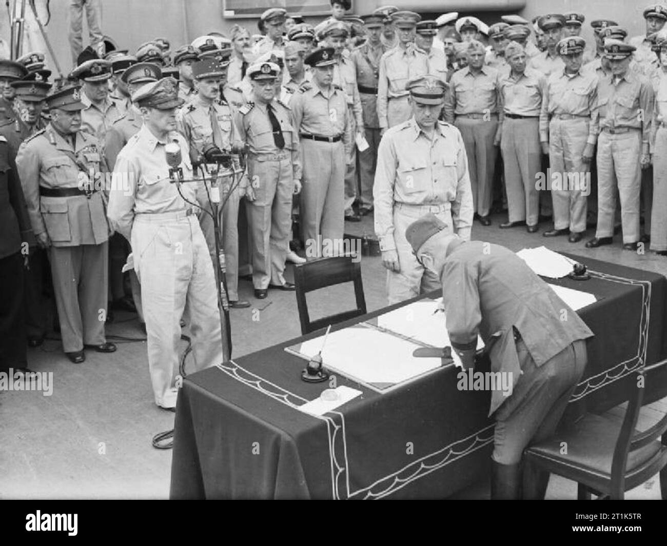 Japanese Surrender at Tokyo Bay, 2 September 1945 General Umezu Yoshijiro signs the surrender on behalf of the Imperial Japanese Army on board USS MISSOURI in Tokyo Bay. Stock Photo